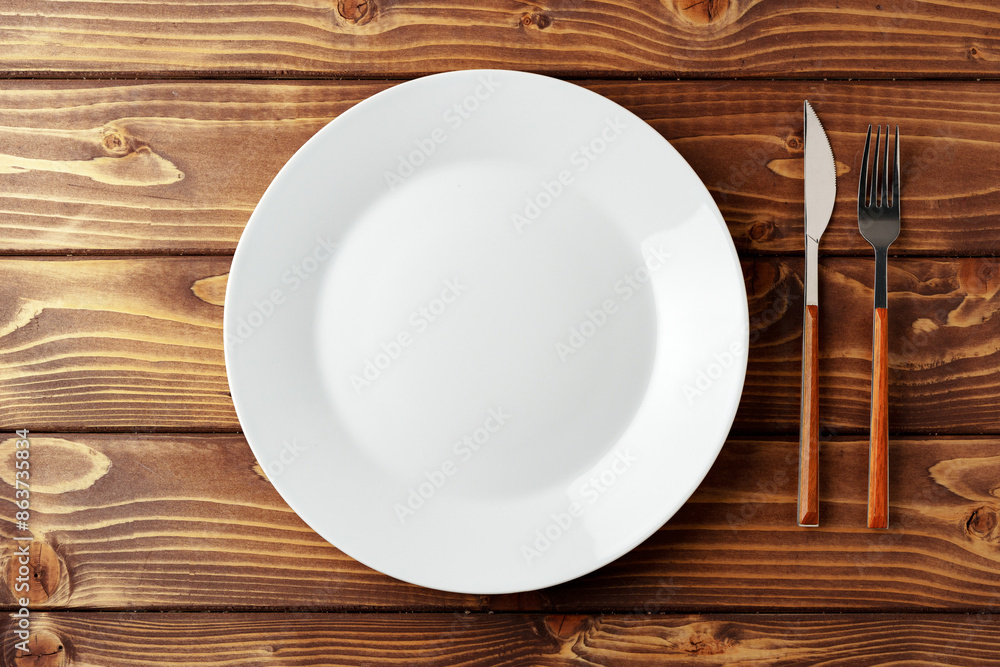 White ceramic tableware on wooden background top view White ceramic tableware on wooden background top view