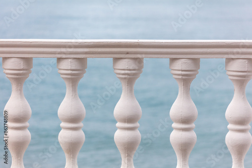 White fence with columns on the seashore