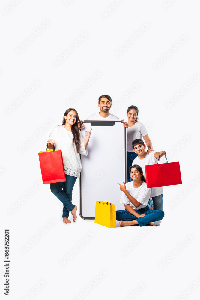 asian Indian family promoting sale offer standing with big tall smartphone cutout
