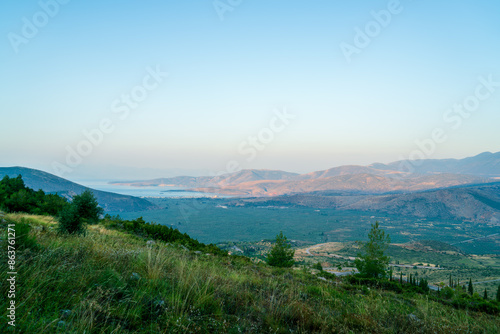 Delphi, Greece. Sunrise over the valley. A streak of light is approaching. Northern coast of the Gulf of Corinth, Itea Bay