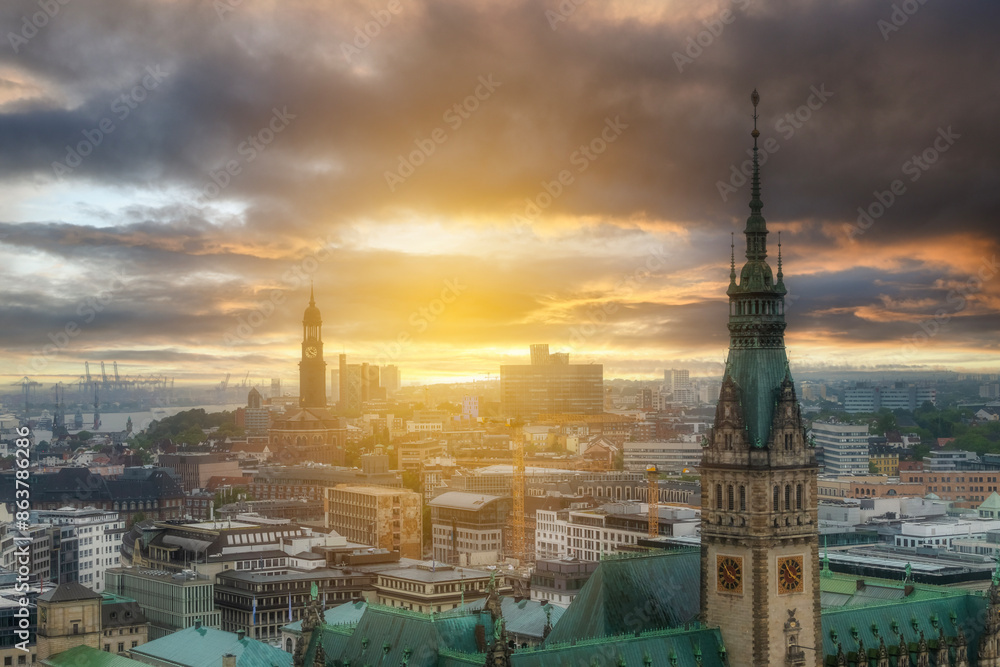 Fototapeta premium General views of the city of Hamburg in northern Germany with sunset clouds and colors Saint Peter's church city hall animals living in the alster lake and around