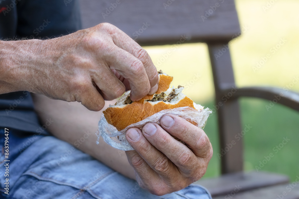 Pie with liver filling.Fragrant pie in the hands of a person.Street food. Pie with liver filling.Fragrant pie in the hands of a person.Street food.
