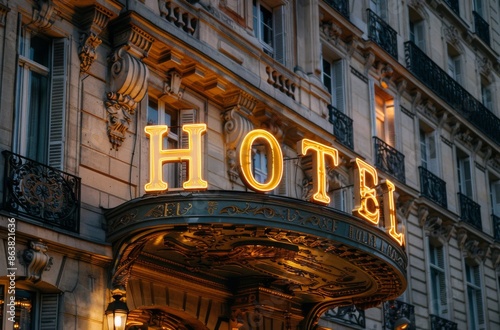 Illuminated Hotel Sign Above Entrance in Paris at Dusk photo