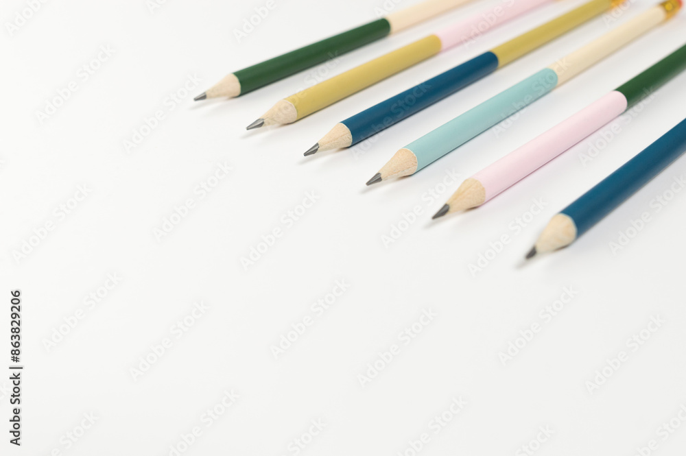 Top view of colorful pencils on white background. School, office, art wallpaper. Flat lay, copy space. Top view of colorful pencils on white background. School, office, art wallpaper. Flat lay, copy space.