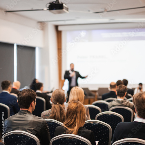 Wallpaper Mural Speaker giving a talk in conference hall at business event. Rear view of unrecognizable people in audience at the conference hall. Business and entrepreneurship concept Torontodigital.ca
