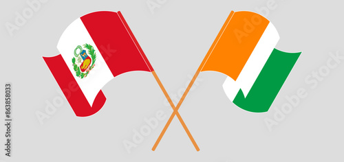 Crossed and waving flags of Peru and Ivory Coast