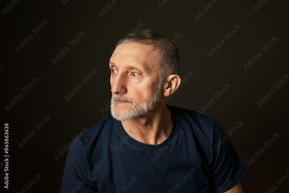 portrait of a handsome elderly man with a beard on a black background, close-up, selective focus portrait of a handsome elderly man with a beard on a black background, close-up, selective focus