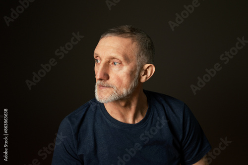 portrait of a handsome elderly man with a beard on a black background, close-up, selective focus