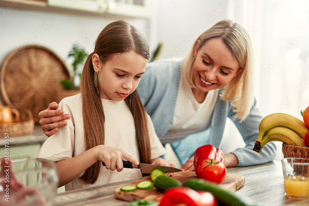 Mother and daughter cooking together in a bright kitchen, enjoying creating meals side by side Mother and daughter cooking together in a bright kitchen, enjoying creating meals side by side