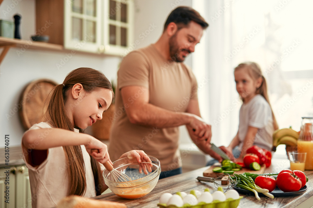 Happy Family Cooking in Kitchen: Father and Children Prepping Vegetables and Baking Happy Family Cooking in Kitchen: Father and Children Prepping Vegetables and Baking