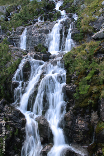 Vertical photo of the silky waterfall on the Transfagarasan mountain road in Romania