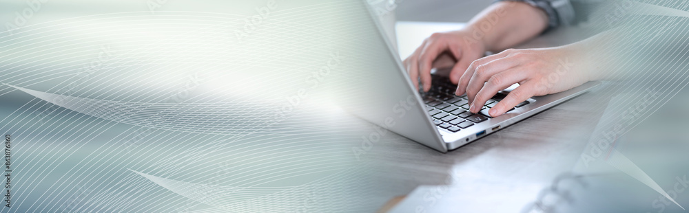 Female hands using laptop; panoramic banner Female hands using laptop; panoramic banner