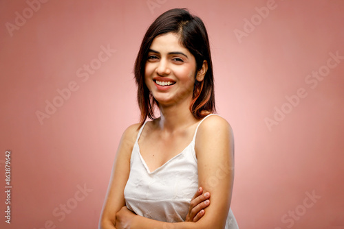 Smiling Brunette Woman With Folded Arms In White Top