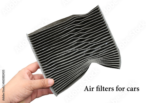 Car air filter on a white background held or held by the left hand, the dust that sticks like this contains both PM 2.5 dust particles and germs that affect the respiratory system.