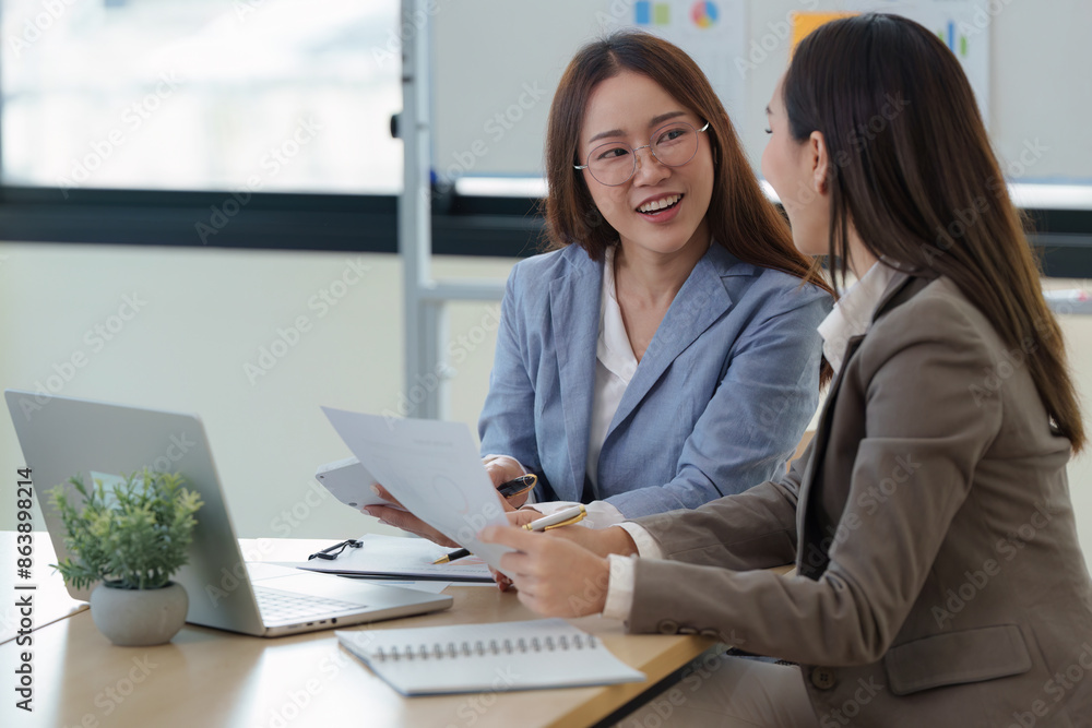 Business women working analyzing with financial data and marketing at meeting room Business women working analyzing with financial data and marketing at meeting room