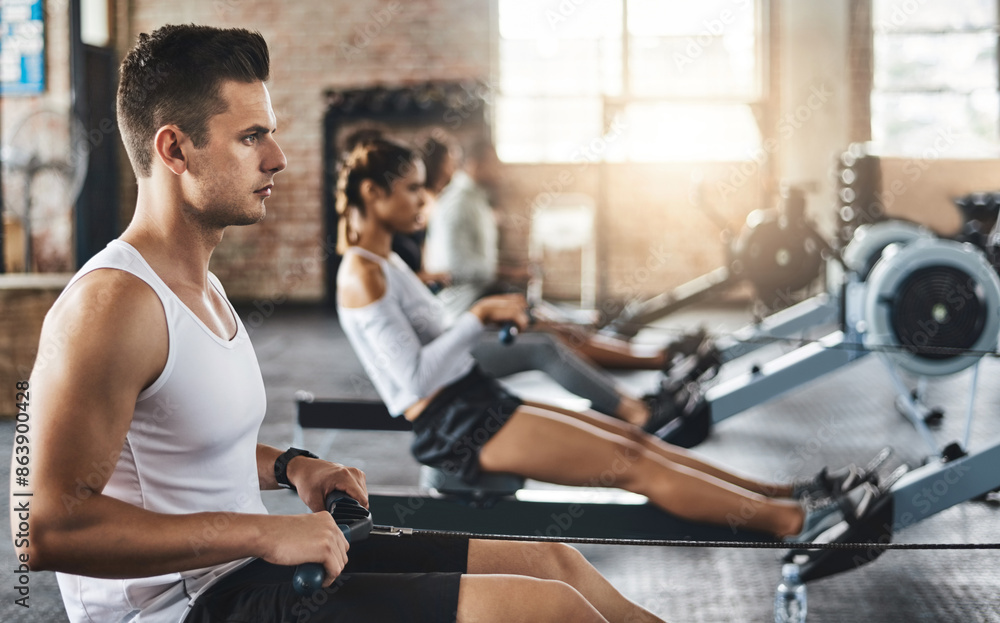Sports, gym and man on rowing machine for health, wellness and body workout with class. Endurance, exercise and male athlete on ergometer equipment for cardio cross training in fitness center.
