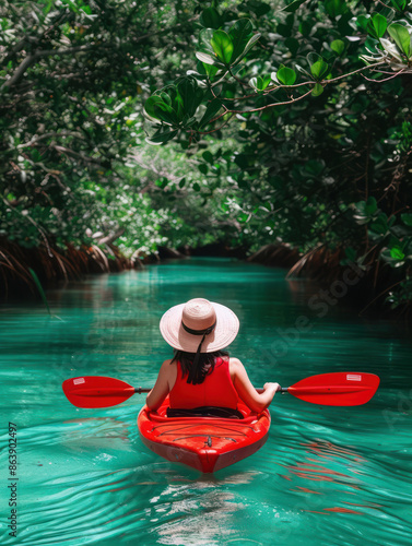 Kayaker paddling through mangroves on a serene coastal adventure, enjoying a sunny day amidst nature, exploring waterways, and experiencing the beauty of the outdoors