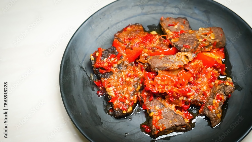 Lung beef (paru balado) cooked in spicy balado seasoning, which is sure to arouse appetite, selective focus and close up Lung beef (paru balado) cooked in spicy balado seasoning, which is sure to arouse appetite, selective focus and close up