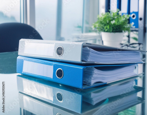 Binders on on glass desk in modern office