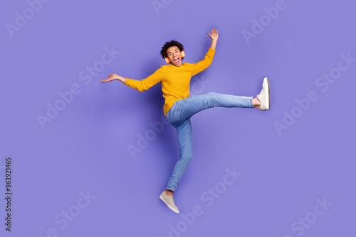 Photo of overjoyed crazy funny man wear trendy yellow clothes have fun good mood isolated on purple color background