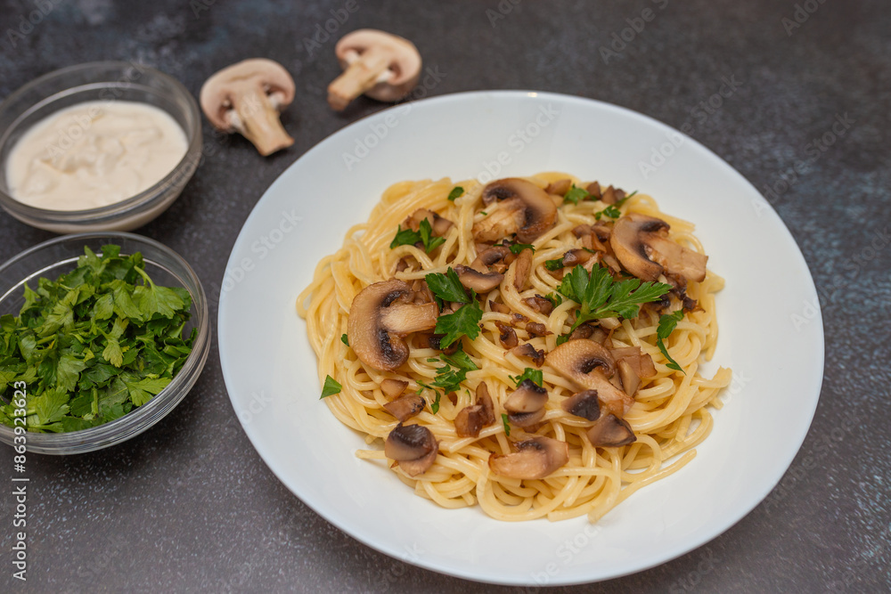 Mushroom Spaghetti Pasta and cream sauce on rustic, dark background, top view, copy space. Homemade italian pasta with champignon mushroom. Mushroom Spaghetti Pasta and cream sauce on rustic, dark background, top view, copy space. Homemade italian pasta with champignon mushroom.
