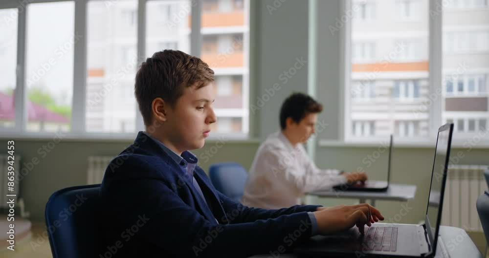 Caucasian Pupils Boys Working With Laptops In Computer-Based Class, Web-Design And Coding Classes Caucasian Pupils Boys Working With Laptops In Computer-Based Class, Web-Design And Coding Classes