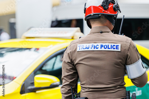 Photography Thai traffic police officer working in busy road in Bangkok city metro operate s