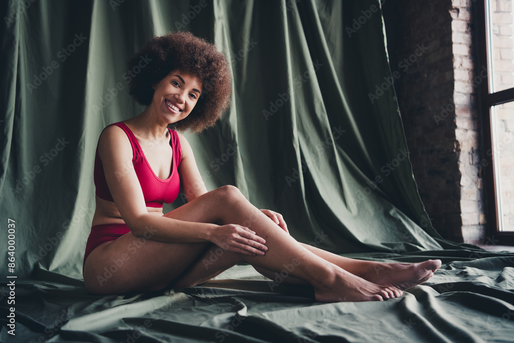 Unretouched photo of happy girl sit touch legs skin feel body positive in studio room Unretouched photo of happy girl sit touch legs skin feel body positive in studio room