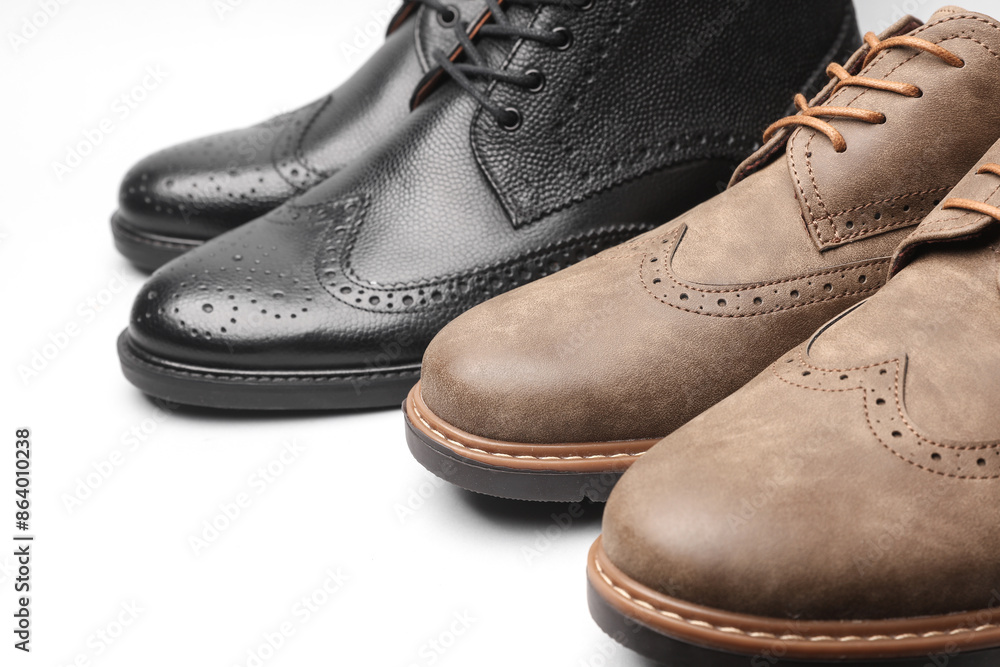 Two pairs of men's brogue shoes on a white background Two pairs of men's brogue shoes on a white background