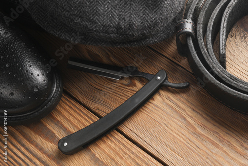 Men's Accessories. Boots, cap and belt on wooden background photo