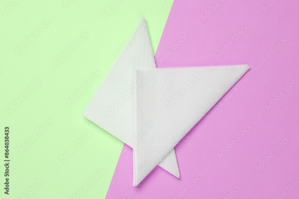 White paper napkins on pink green background. Top view White paper napkins on pink green background. Top view