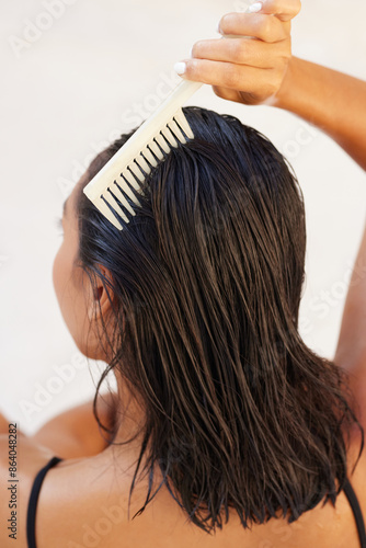 Woman Combing Wet Hair With White Wide-Tooth Comb For Smooth, Tangle-Free Hair Care
