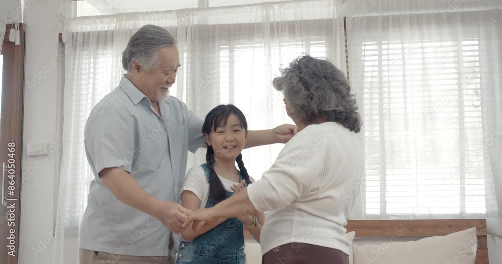 Grand parents spend times on holiday with granddaughter in living room at home. Grand parents spend times on holiday with granddaughter in living room at home.