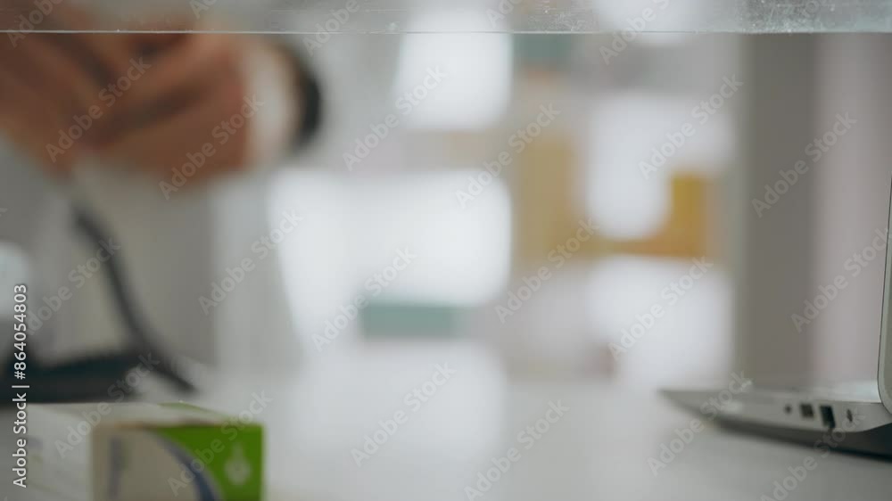 A pharmacist dressed in a white coat accepts payment using a smartwatch at a pharmaceutical point. A modern man controls the payment process with a smart watch online payment, care A pharmacist dressed in a white coat accepts payment using a smartwatch at a pharmaceutical point. A modern man controls the payment process with a smart watch online payment, care
