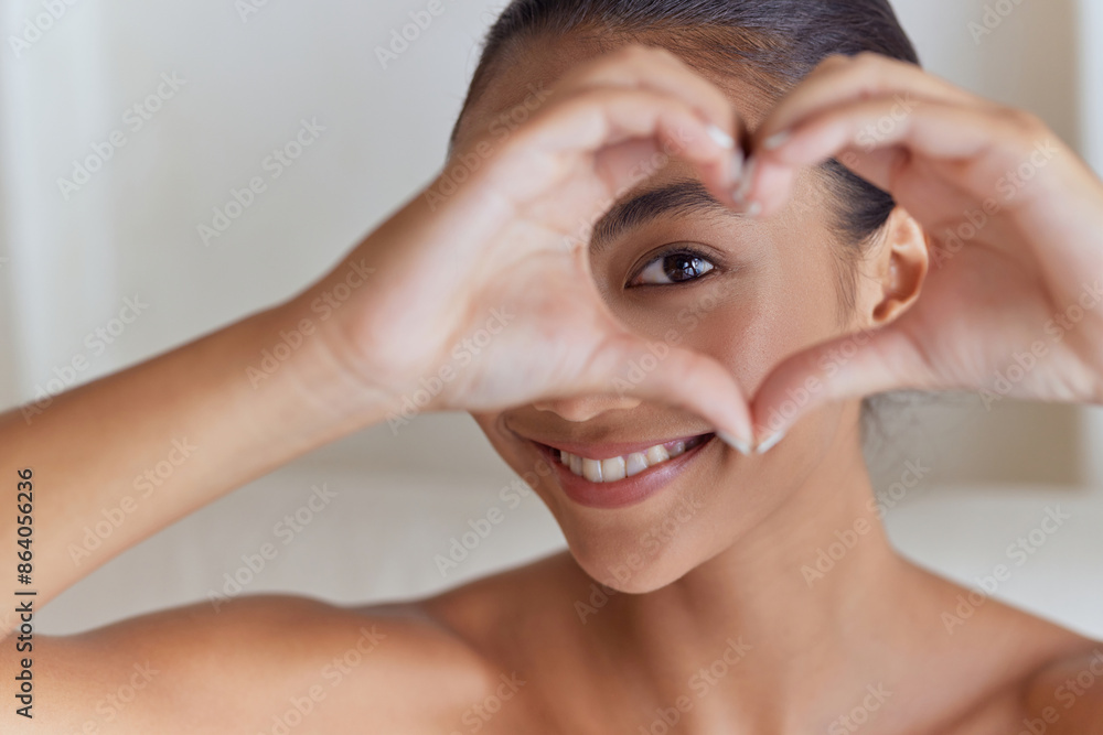 Smiling Woman Framing Eye With Hands In Heart Shape, Promoting Eye Care And Positivity Smiling Woman Framing Eye With Hands In Heart Shape, Promoting Eye Care And Positivity