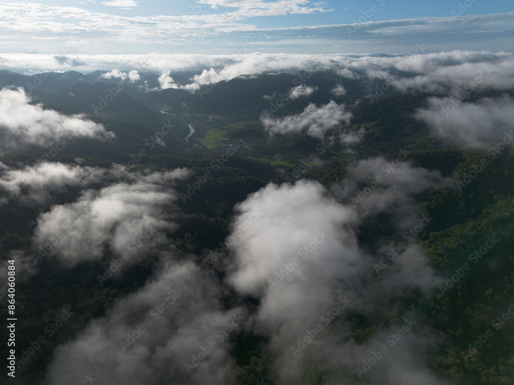 A high-angle landscape, dense fog, natural forest mountains covered in fog. A bright sky and beautiful landscape can be viewed from the sky with a drone. A high-angle landscape, dense fog, natural forest mountains covered in fog. A bright sky and beautiful landscape can be viewed from the sky with a drone.