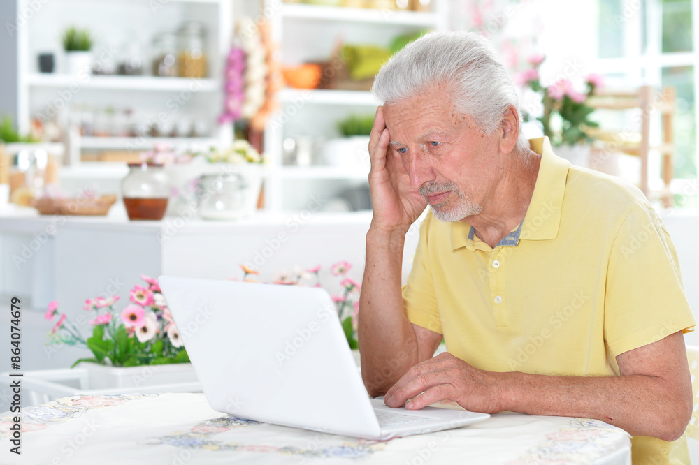 Portrait of senior man with laptop at home Portrait of senior man with laptop at home