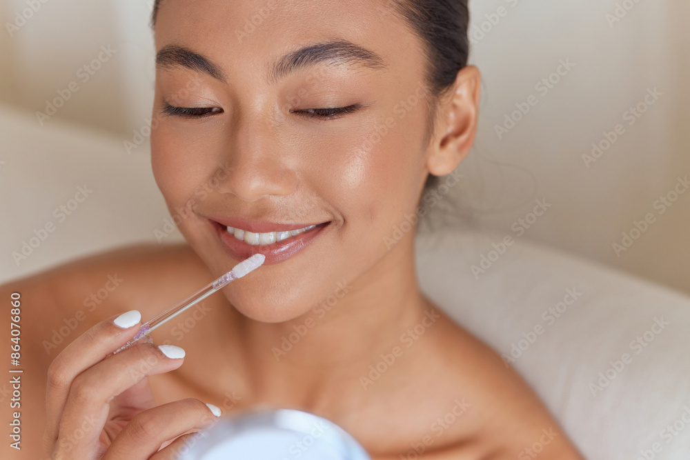 Woman Applying Lip Gloss Smiling, Skincare, Beauty, Makeup, Natural Glow, Self-Care, Close-Up, Smooth Skin