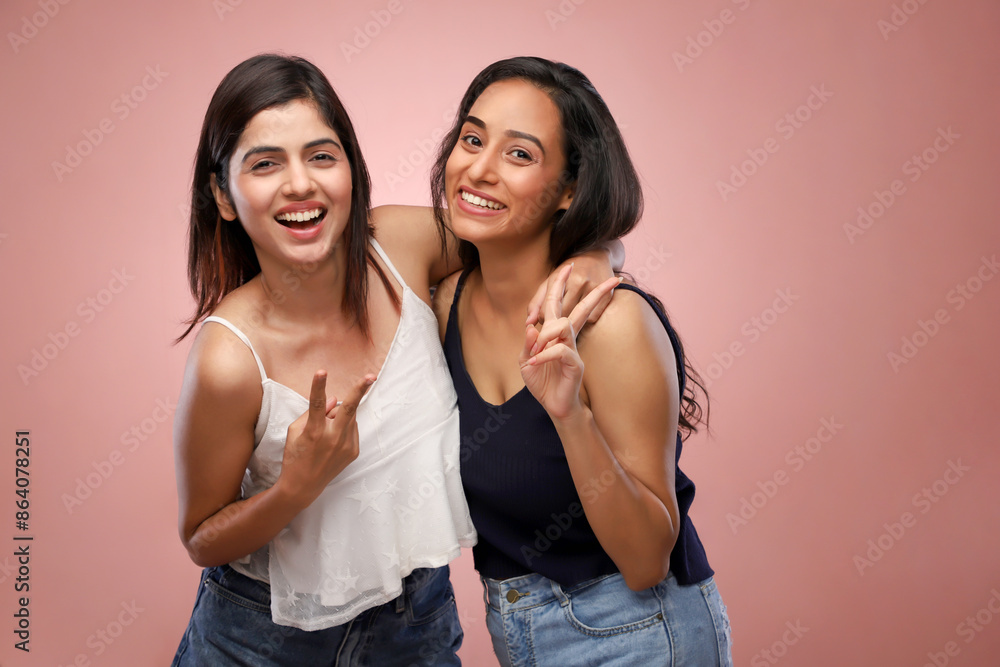Two Pretty Women Dressed In Casual Outfits Showing The Victory Hand Sign Two Pretty Women Dressed In Casual Outfits Showing The Victory Hand Sign