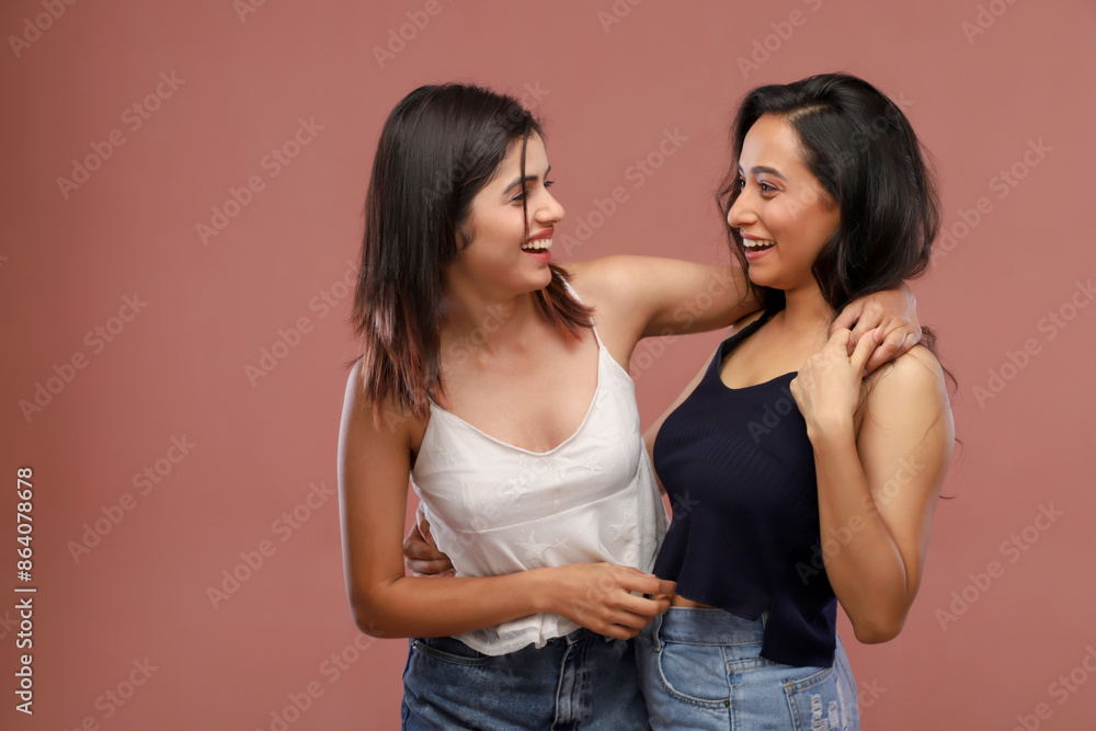 Two Beautiful Mature Women Looking At Each Other While Smiling Two Beautiful Mature Women Looking At Each Other While Smiling