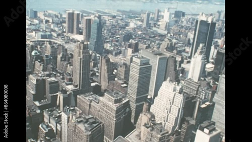 New York, Midtown Manhattan, United States America 1976: Herald square and Macy's store of New York with historic buildings and road traffic. Archival skyline of New York with on East river in 1970s.