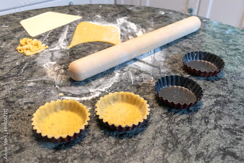 close up of how to make tart pie with dough in the kitchen before baking.   photo