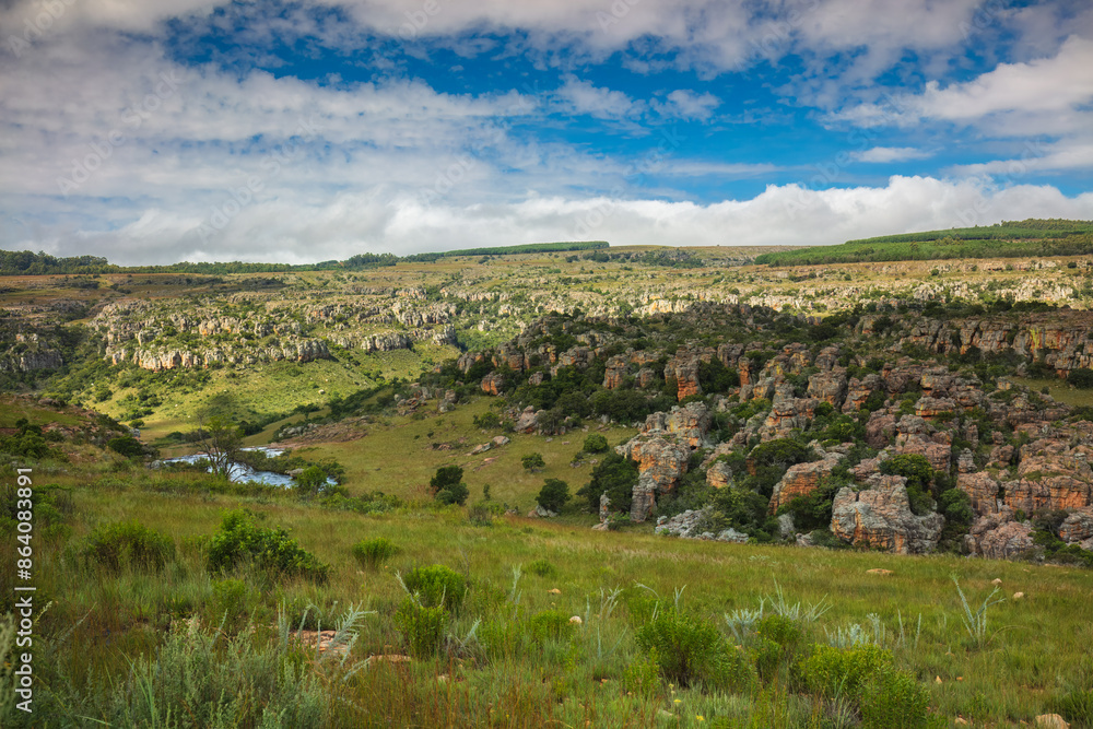 Naklejka premium Lisbon Falls and Lisbon river gorge during sunset, Panorama Route, Mpumalanga, South Africa, shot from wild grassland