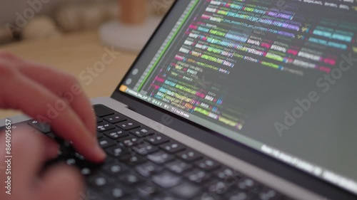 Wallpaper Mural Programmer's Hands Typing Code on Keyboard with Colored Source Code. Torontodigital.ca