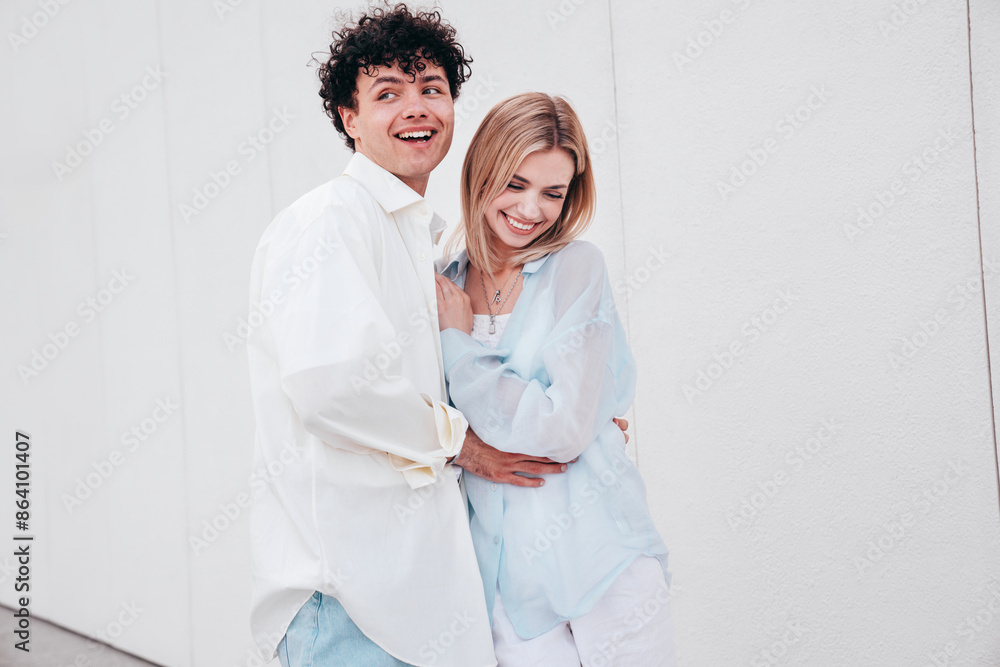 Smiling beautiful woman and her handsome boyfriend. Couple in casual summer clothes. Happy cheerful family. Female and man having fun. They posing in the street in sunny day. Having tender moments Smiling beautiful woman and her handsome boyfriend. Couple in casual summer clothes. Happy cheerful family. Female and man having fun. They posing in the street in sunny day. Having tender moments
