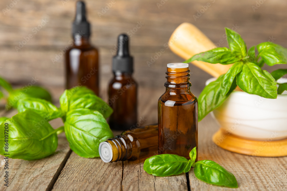 Basil essential oil on a textured wooden background. Basil essential oil and fresh leaves. Aromatherapy. Aroma oil. Medical herbs. Alternative medicine. Place for text. Copy space. Basil essential oil on a textured wooden background. Basil essential oil and fresh leaves. Aromatherapy. Aroma oil. Medical herbs. Alternative medicine. Place for text. Copy space.