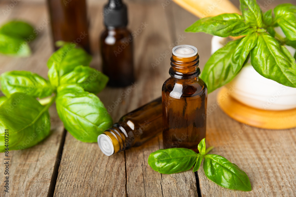 Basil essential oil on a textured wooden background. Basil essential oil and fresh leaves. Aromatherapy. Aroma oil. Medical herbs. Alternative medicine. Place for text. Copy space. Basil essential oil on a textured wooden background. Basil essential oil and fresh leaves. Aromatherapy. Aroma oil. Medical herbs. Alternative medicine. Place for text. Copy space.