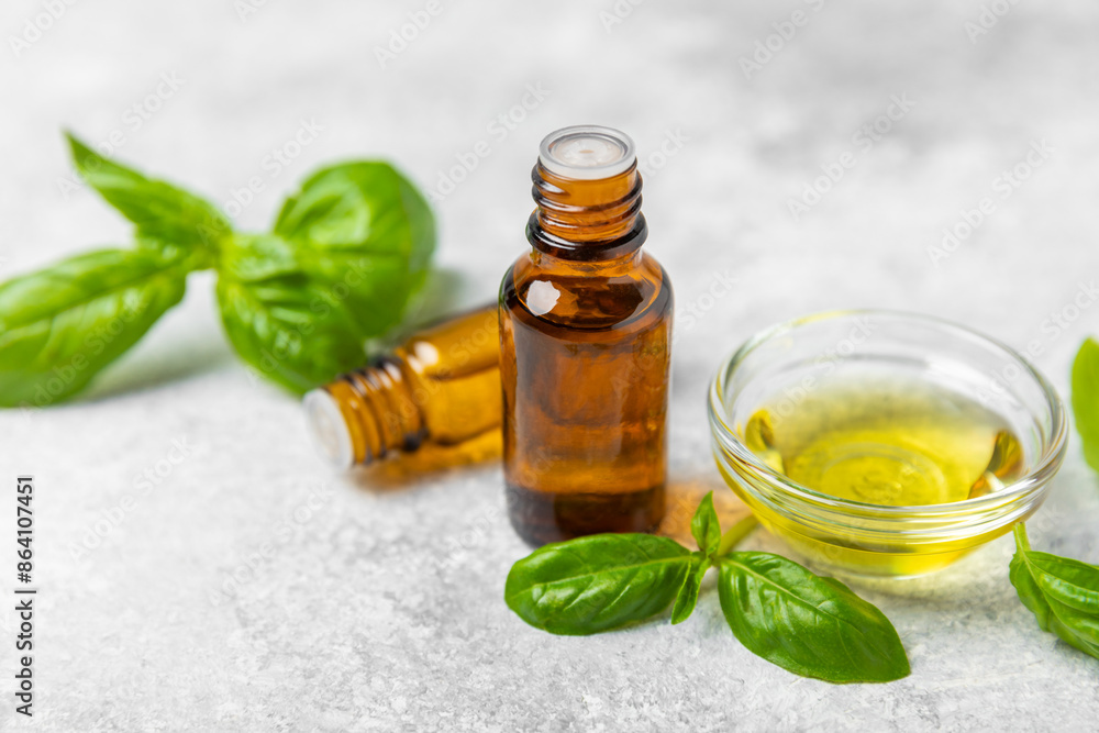 Basil essential oil on a textured wooden background. Basil essential oil and fresh leaves. Aromatherapy. Aroma oil. Medical herbs. Alternative medicine. Place for text. Copy space. Basil essential oil on a textured wooden background. Basil essential oil and fresh leaves. Aromatherapy. Aroma oil. Medical herbs. Alternative medicine. Place for text. Copy space.