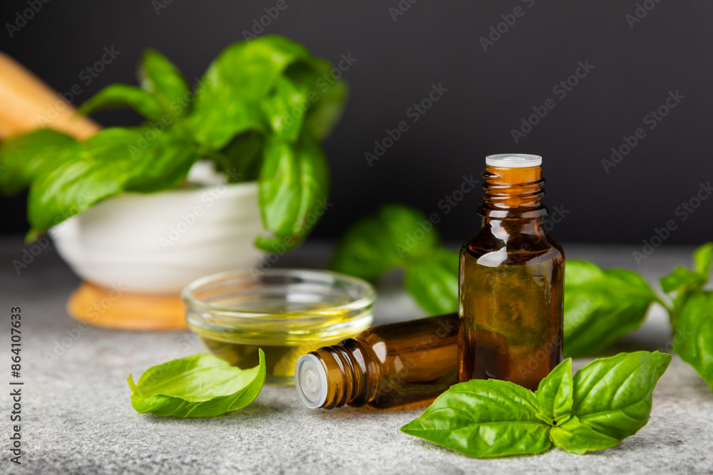 Basil essential oil on a textured wooden background. Basil essential oil and fresh leaves. Aromatherapy. Aroma oil. Medical herbs. Alternative medicine. Place for text. Copy space. Basil essential oil on a textured wooden background. Basil essential oil and fresh leaves. Aromatherapy. Aroma oil. Medical herbs. Alternative medicine. Place for text. Copy space.