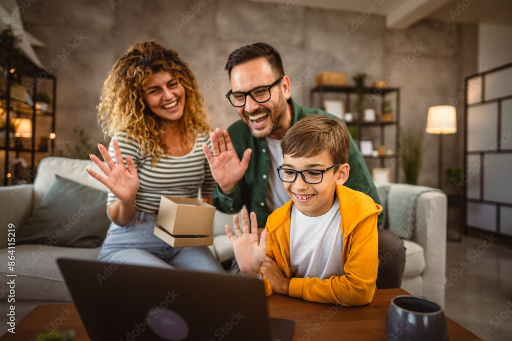 Parents with son open gift box and have video call on laptop Parents with son open gift box and have video call on laptop
